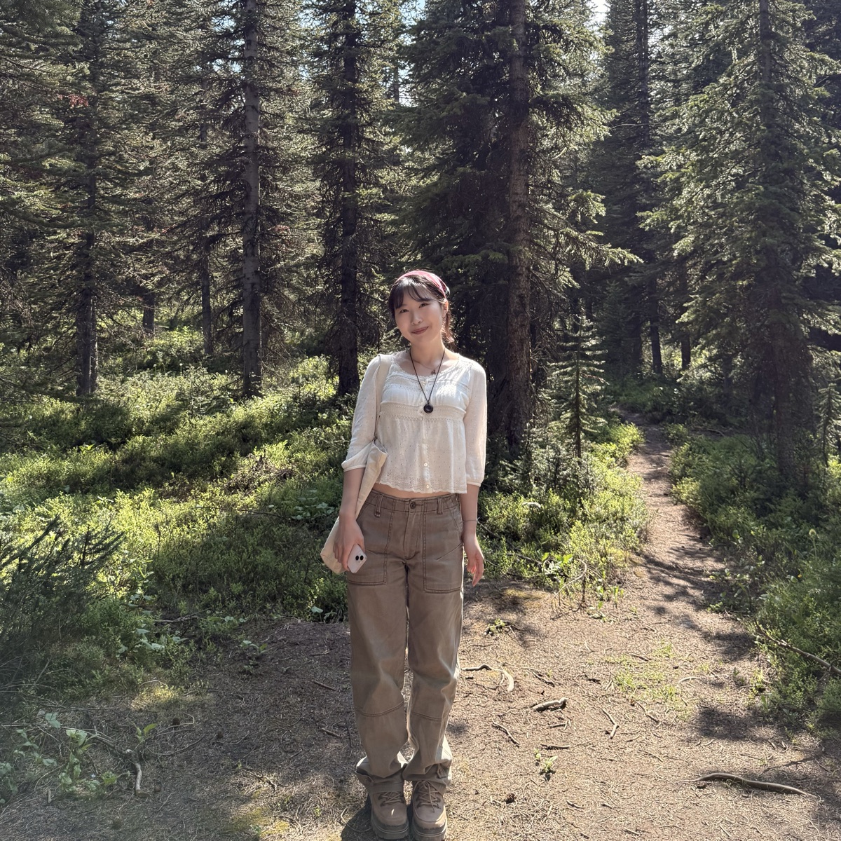 Sumin standing on a forest trail